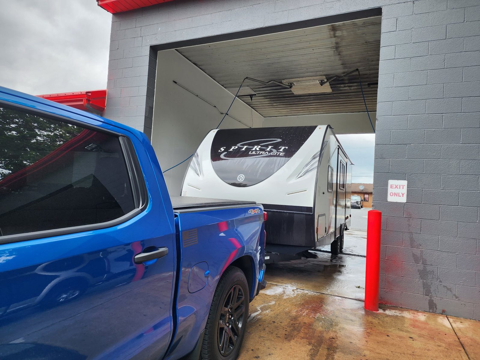 A pickup truck towing a camper through one of Lanco's tall truck bays