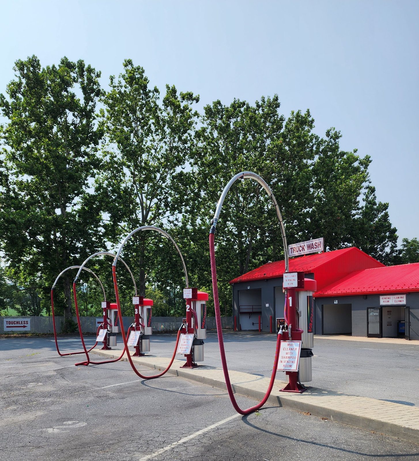 The vacuum row at Lanco Wash N Shine, with the truck wash building behind